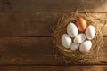 Eggcellent display Wooden background frames chicken eggs in rustic nest Royalty Free Stock Photo