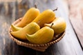 Eggfruit or canistel in a basket on wooden table