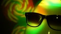 Egghead man in sunglasses in the multicolored spotlight