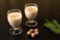Eggnog Christmas cocktail on a black background with whole nutmeg Royalty Free Stock Photo