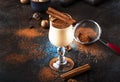 Eggnog cocktail hot winter or autumn drink with milk, eggs and dark rum, sprinkled with cinnamon and nutmeg in shot glass on blue Royalty Free Stock Photo