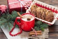 Eggnog cocktail in mug arranged with christmas decoration and c