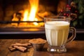 eggnog in a glass next to a cozy fireplace in a lodge Royalty Free Stock Photo