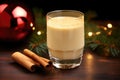 eggnog in a modern glass next to a glossy holiday bauble