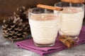 Eggnog traditional xmas homemade winter egg, milk, rum, vanilla alcohol liqueur preparation recipe in two glass cups with cinnamon Royalty Free Stock Photo