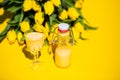 Eggnog with yellow tulips on a yellow background