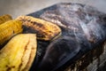 Eggplant, corn and sausages smoking on a barbecue grill Royalty Free Stock Photo