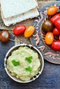 Eggplant dip in bowl with grape tomatoes on rustic table Royalty Free Stock Photo