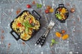 Eggplant, olives and tomato Elbow macaroni pasta, on a black serving platter Royalty Free Stock Photo