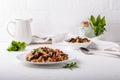 Eggplant pilaf served in white plate. Rice with aubergine,  black raisins and tomatoes on white table. Healthy vegetarian food Royalty Free Stock Photo