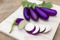 Eggplant violet raw on wooden cutting board and on sackcloth background, it is vegetable food for healthy