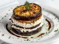 Eggplants fried in boiling oil and elegantly arranged in layers on top of each other with ricotta