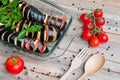 Eggplants sliced for baking with cheese and tomatoes in a transparent bowl Royalty Free Stock Photo