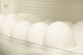 White eggs stored in a tray in a kitchen refrigerator during a sunny afternoon Royalty Free Stock Photo