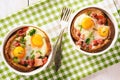 Eggs baked with bacon, tomatoes, garlic and bread. Royalty Free Stock Photo