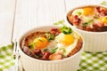 Eggs baked with bacon, tomatoes, garlic and bread. Royalty Free Stock Photo