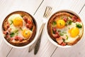 Eggs baked with bacon, tomatoes, garlic and bread. Royalty Free Stock Photo