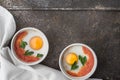 Eggs baked with tomatoes and parsley in the ramekins on the metal background top view Royalty Free Stock Photo