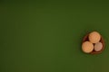 Eggs in a basket on a green background. Royalty Free Stock Photo