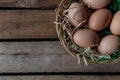 Top view rustic style eggs in basket on wooden background with copy space Royalty Free Stock Photo