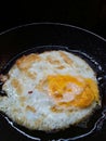 Eggs being fried on a frying pan. Fried egg. Selective focus. Royalty Free Stock Photo