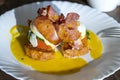 Eggs Benedict with bacon, toast bread and tomato, closeup. Sandwich with poached egg for cooked breakfast Royalty Free Stock Photo