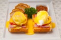 Eggs benedict on bread with tomato and ham Royalty Free Stock Photo