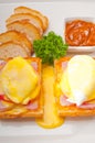 Eggs benedict on bread with tomato and ham Royalty Free Stock Photo