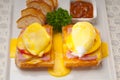 Eggs benedict on bread with tomato and ham Royalty Free Stock Photo