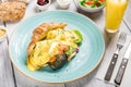 Eggs Benedict Breakfast Plate with Salmon and Croissant, Gourmet Lunch: Tasty Fried Eggs and Toasted Croissant Royalty Free Stock Photo