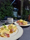 Eggs Benedict with ham, topped with hollandaize sauce and served with coffee at a brunch Royalty Free Stock Photo