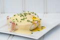 Eggs Benedict toasted English muffins ham poached eggs and hollandaise sauce Royalty Free Stock Photo