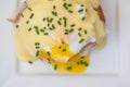 Eggs Benedict toasted English muffins ham poached eggs and hollandaise sauce