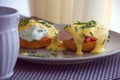 Eggs Benedict- toasted muffins, ham, poached eggs, and delicious buttery hollandaise sauce Royalty Free Stock Photo