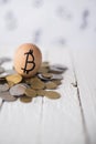 Eggs bitcoins on coins on a wooden background Royalty Free Stock Photo