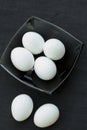 Eggs in a black bowl isoated on black background. Royalty Free Stock Photo