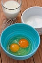 Eggs in a blue bowl and a glass of milk Royalty Free Stock Photo