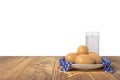 Eggs on blue towel in ceramic bowl on wooden table with glass of milk. Isolated on white background. Royalty Free Stock Photo