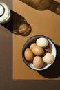 Eggs in a bowl with a bottle of milk ÃÂ±n brown background Royalty Free Stock Photo