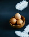 Eggs in a bowl and feathers fall background wallpaper