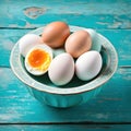 Eggs in a bowl on a surface resembling vintage turquoise.