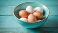 Eggs in a bowl on a surface resembling vintage turquoise.