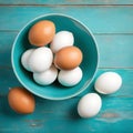 Eggs in a bowl on a surface resembling vintage turquoise.