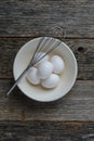 Eggs in a Bowl with a Whisk on Rustic Wood Royalty Free Stock Photo