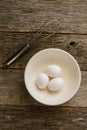 Eggs in a Bowl with a Whisk on Rustic Wood Royalty Free Stock Photo