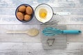 Eggs in a box with a whisk on a rustic wood table Royalty Free Stock Photo