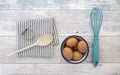 Eggs in a box with a whisk on a rustic wood table Royalty Free Stock Photo