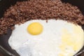 Eggs with buckwheat on fruing pan closeup Royalty Free Stock Photo