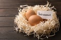 Eggs and card with word RETIREMENT in nest on wooden background Royalty Free Stock Photo