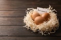 Eggs and card with word RETIREMENT in nest on wooden background, space for text Royalty Free Stock Photo